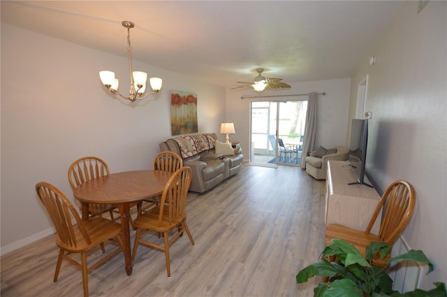 12538 SW Kingsway Cir Unit 1602, Lake Suzy, FL 34269 - dining room featuring light wood finished floors, a chandelier, baseboards, and a ceiling fan