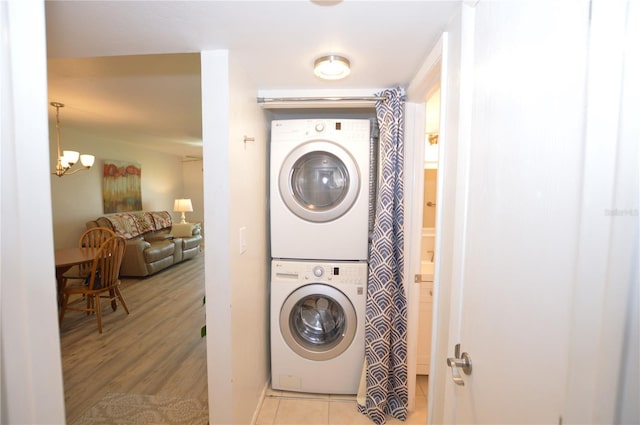 12538 SW Kingsway Cir Unit 1602, Lake Suzy, FL 34269 - laundry area with stacked washer / dryer, a chandelier, and light tile patterned floors