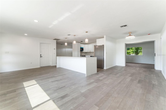 1231 Beacon Dr, Port Charlotte, FL 33952 - unfurnished living room with light wood-type flooring, baseboards, and recessed lighting
