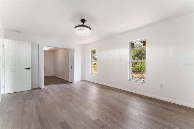 1231 Beacon Dr, Port Charlotte, FL 33952 - unfurnished room with wood finished floors, baseboards, and a smoke detector