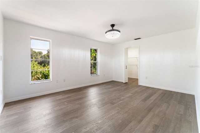 1231 Beacon Dr, Port Charlotte, FL 33952 - empty room with healthy amount of natural light, wood finished floors, and baseboards