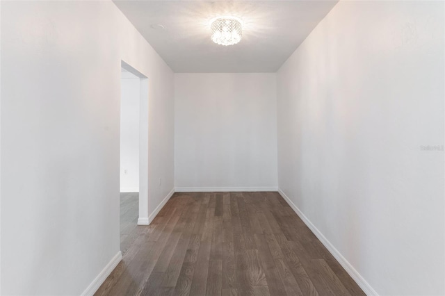 1231 Beacon Dr, Port Charlotte, FL 33952 - empty room featuring wood finished floors, a chandelier, and baseboards