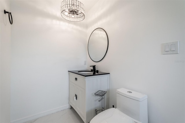 1231 Beacon Dr, Port Charlotte, FL 33952 - bathroom with toilet, marble look tiles, vanity, a chandelier, and baseboards