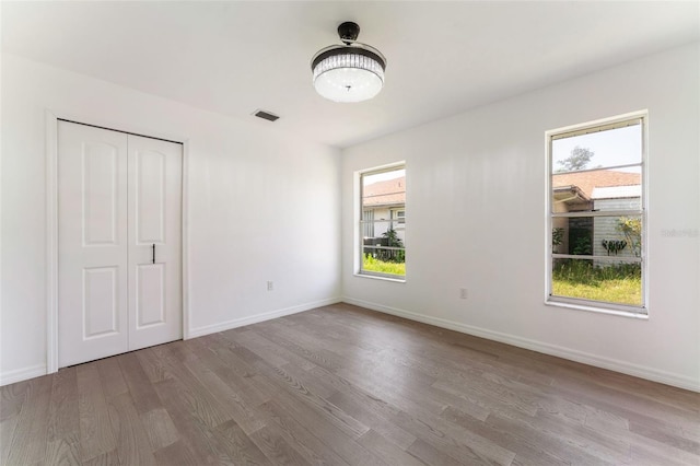 1231 Beacon Dr, Port Charlotte, FL 33952 - unfurnished bedroom featuring wood finished floors, baseboards, and a closet