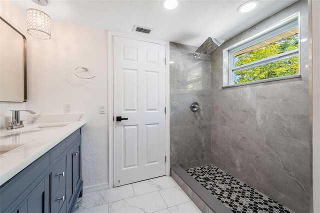 1231 Beacon Dr, Port Charlotte, FL 33952 - bathroom featuring double vanity, marble look tiles, a tile shower, and recessed lighting
