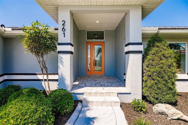 261 Venezia Ct, Punta Gorda, FL 33950 - doorway to property with stucco siding and metal roof