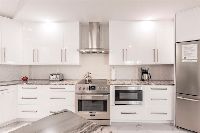 261 Venezia Ct, Punta Gorda, FL 33950 - kitchen featuring appliances with stainless steel finishes, wall chimney range hood, modern cabinets, and light marble finish flooring
