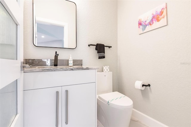 261 Venezia Ct, Punta Gorda, FL 33950 - bathroom with toilet, vanity, and baseboards