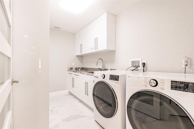 261 Venezia Ct, Punta Gorda, FL 33950 - washroom featuring washing machine and clothes dryer, cabinet space, light marble finish flooring, and baseboards