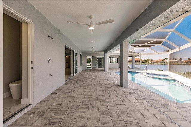 261 Venezia Ct, Punta Gorda, FL 33950 - view of swimming pool featuring a patio area, ceiling fan, glass enclosure, a pool with connected hot tub, and a water view