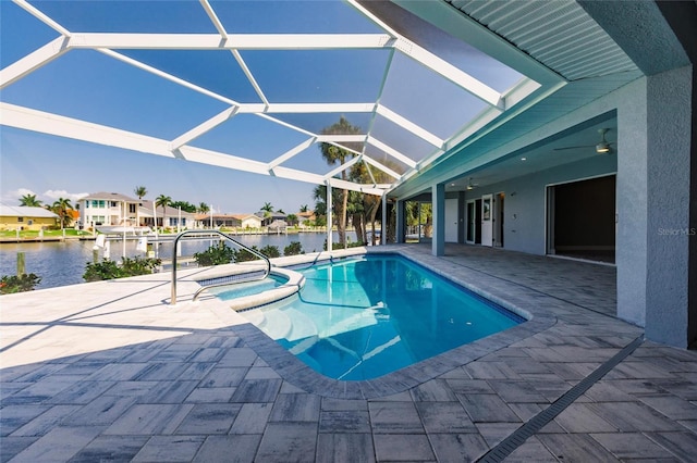 261 Venezia Ct, Punta Gorda, FL 33950 - view of swimming pool with a patio area, a pool with connected hot tub, a water view, glass enclosure, and a residential view