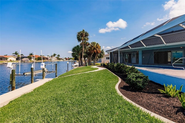 261 Venezia Ct, Punta Gorda, FL 33950 - view of grassy yard featuring a boat dock, a water view, glass enclosure, and boat lift