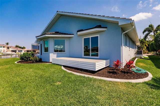 261 Venezia Ct, Punta Gorda, FL 33950 - rear view of property with stucco siding, a yard, and a water view