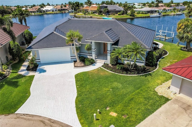 261 Venezia Ct, Punta Gorda, FL 33950 - view of front of house with a residential view, a garage, a water view, driveway, and a front lawn