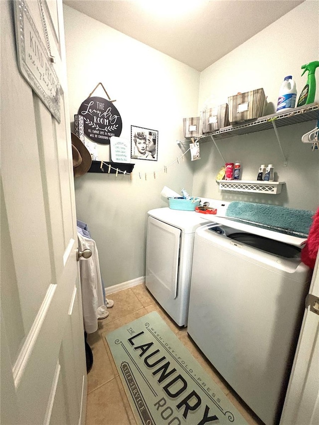 25008 Lalique Pl, Punta Gorda, FL 33950 - washroom with light tile patterned floors, washing machine and clothes dryer, and baseboards