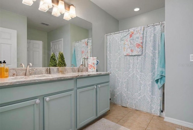 25008 Lalique Pl, Punta Gorda, FL 33950 - full bath featuring double vanity, tile patterned flooring, baseboards, and a shower with curtain