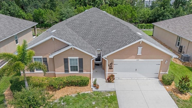 7652 Mikasa Dr, Punta Gorda, FL 33950 - ranch-style home with a garage, concrete driveway, stucco siding, and central AC