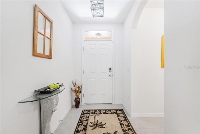 7652 Mikasa Dr, Punta Gorda, FL 33950 - doorway to outside with arched walkways, baseboards, and light tile patterned floors