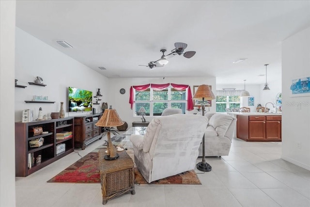 7652 Mikasa Dr, Punta Gorda, FL 33950 - living room with ceiling fan, light tile patterned flooring, and baseboards