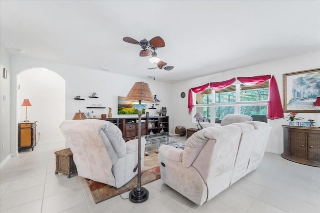 7652 Mikasa Dr, Punta Gorda, FL 33950 - living area with ceiling fan, arched walkways, light tile patterned floors, and baseboards