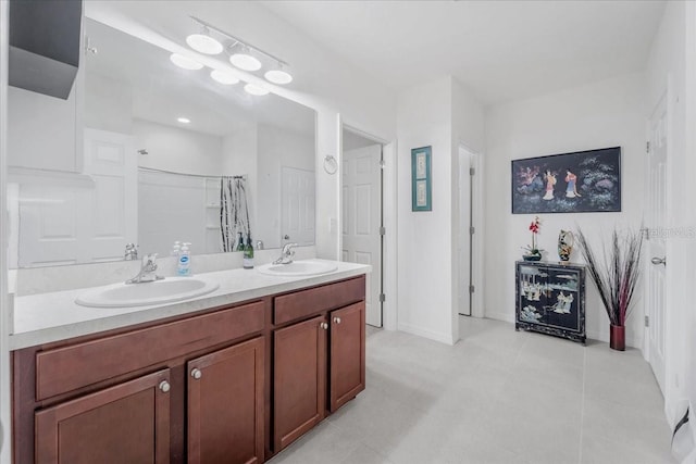 7652 Mikasa Dr, Punta Gorda, FL 33950 - bathroom featuring double vanity, curtained shower, baseboards, and tile patterned floors