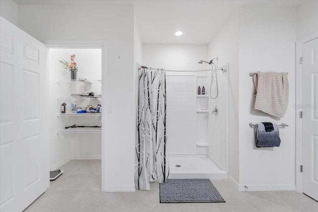 7652 Mikasa Dr, Punta Gorda, FL 33950 - bathroom with tiled shower, tile patterned flooring, baseboards, and recessed lighting