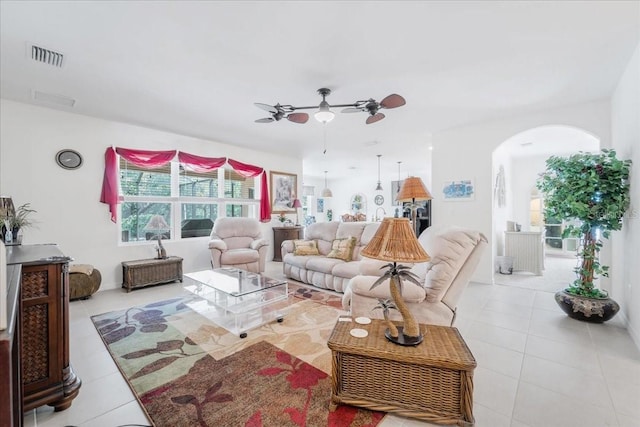 7652 Mikasa Dr, Punta Gorda, FL 33950 - living room featuring arched walkways, tile patterned flooring, and a ceiling fan