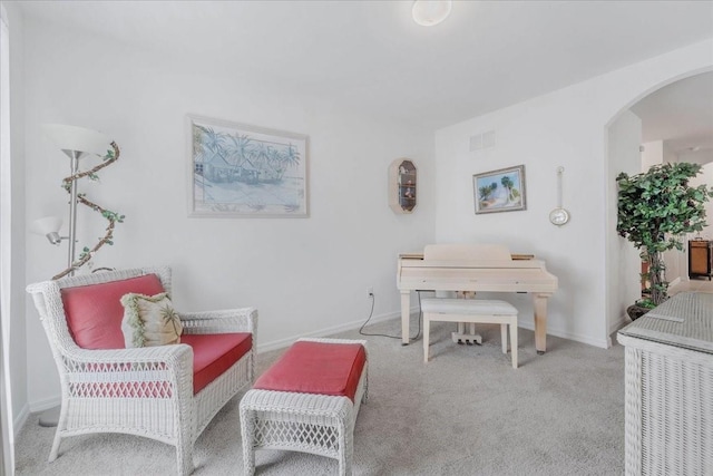 7652 Mikasa Dr, Punta Gorda, FL 33950 - living area featuring carpet flooring, arched walkways, and baseboards