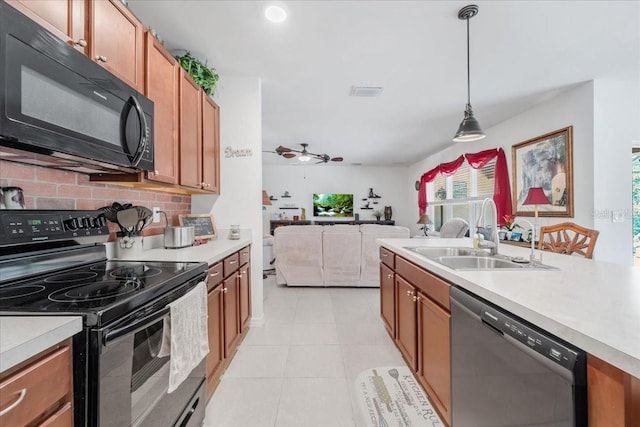 7652 Mikasa Dr, Punta Gorda, FL 33950 - kitchen featuring black appliances, a sink, light countertops, and open floor plan