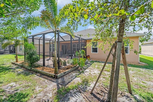 7652 Mikasa Dr, Punta Gorda, FL 33950 - back of property with stucco siding, a yard, a patio area, and a lanai