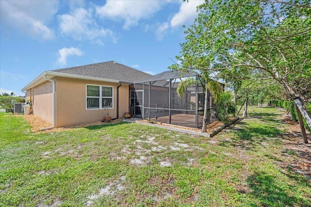 7652 Mikasa Dr, Punta Gorda, FL 33950 - back of house featuring stucco siding, cooling unit, a lawn, and a lanai