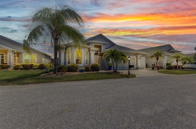 24358 Folkstone Ave, Punta Gorda, FL 33980 - ranch-style home with an attached garage, concrete driveway, a front yard, and stucco siding