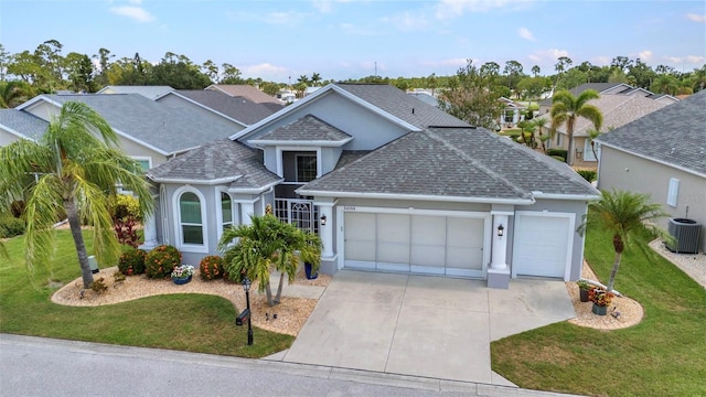 24358 Folkstone Ave, Punta Gorda, FL 33980 - traditional-style house with an attached garage, central AC unit, roof with shingles, driveway, and a front yard