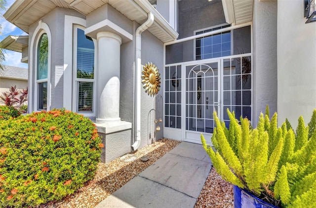 24358 Folkstone Ave, Punta Gorda, FL 33980 - doorway to property featuring stucco siding