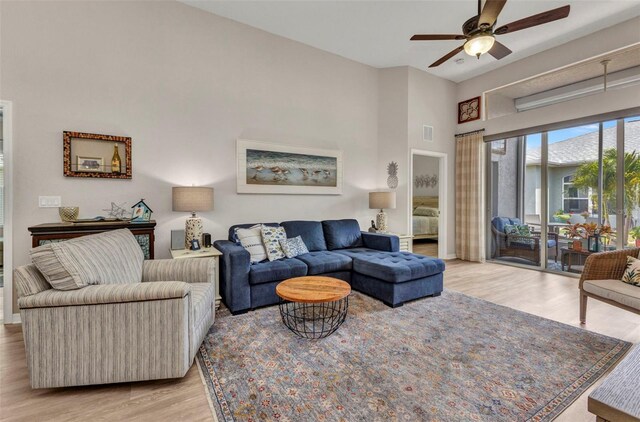24358 Folkstone Ave, Punta Gorda, FL 33980 - living area featuring a ceiling fan, light wood-type flooring, a towering ceiling, and baseboards