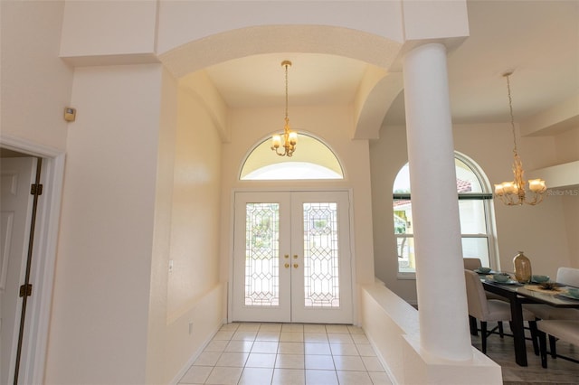 3506 Saint Florent Ct, Punta Gorda, FL 33950 - entrance foyer featuring a chandelier, arched walkways, healthy amount of natural light, and light tile patterned flooring