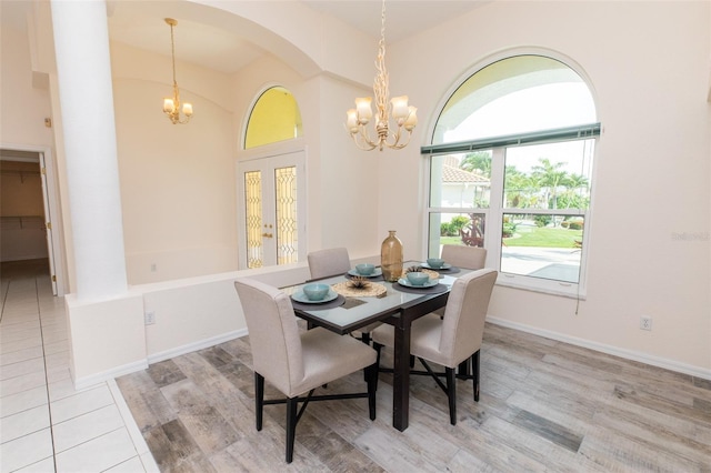 3506 Saint Florent Ct, Punta Gorda, FL 33950 - dining area featuring a chandelier, arched walkways, and light wood-style flooring