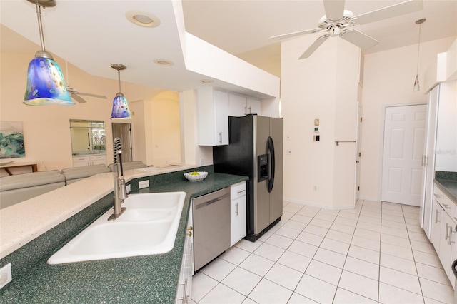 3506 Saint Florent Ct, Punta Gorda, FL 33950 - kitchen featuring appliances with stainless steel finishes, ceiling fan, white cabinetry, pendant lighting, and vaulted ceiling