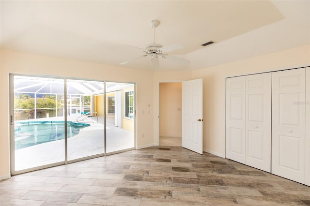 3506 Saint Florent Ct, Punta Gorda, FL 33950 - unfurnished bedroom with a sunroom, access to exterior, light wood finished floors, and multiple windows