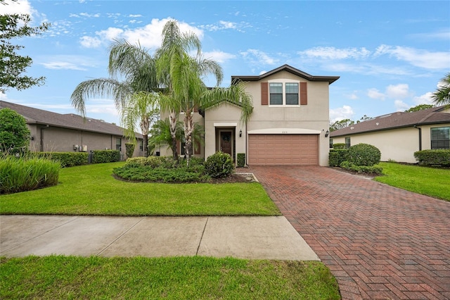 2515 Sherman Oak Dr, North Port, FL 34289 - traditional-style home with decorative driveway, an attached garage, stucco siding, and a front yard