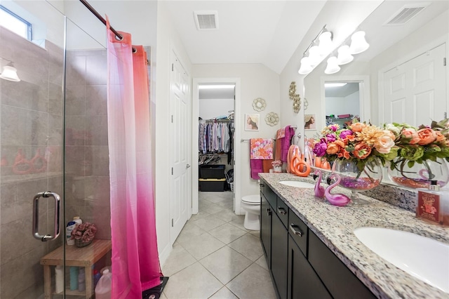 2515 Sherman Oak Dr, North Port, FL 34289 - bathroom with a shower stall, double vanity, tile patterned floors, a spacious closet, and toilet