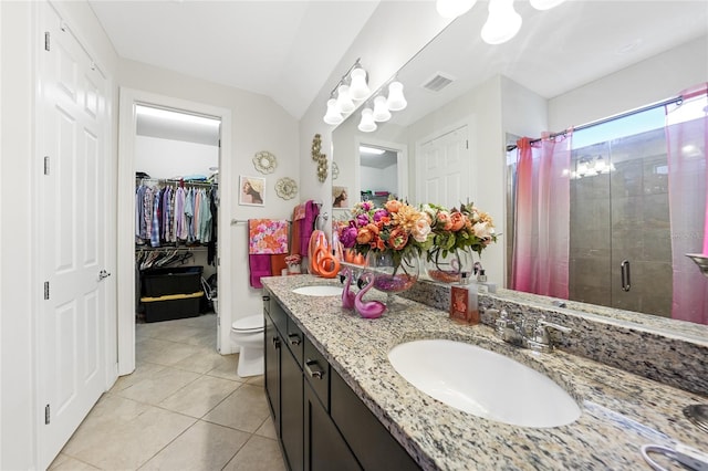 2515 Sherman Oak Dr, North Port, FL 34289 - full bath with a shower stall, tile patterned floors, double vanity, a spacious closet, and toilet