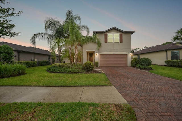 2515 Sherman Oak Dr, North Port, FL 34289 - traditional-style house with decorative driveway, a garage, stucco siding, and a yard