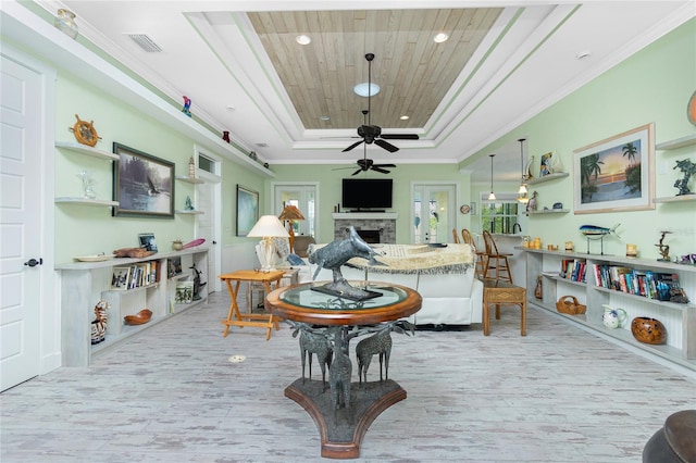 13204 Kakapo Ave, Port Charlotte, FL 33981 - living room with a raised ceiling, a fireplace, a ceiling fan, wood finished floors, and wooden ceiling