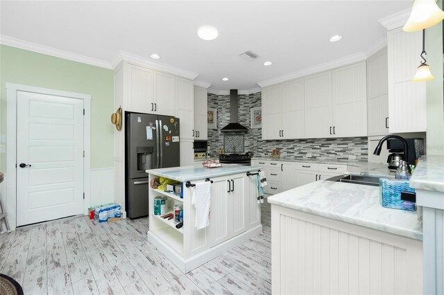 13204 Kakapo Ave, Port Charlotte, FL 33981 - kitchen with stainless steel fridge, a sink, wall chimney range hood, ornamental molding, and backsplash