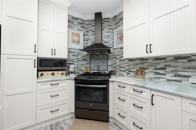 13204 Kakapo Ave, Port Charlotte, FL 33981 - kitchen with gas range, wall chimney range hood, stainless steel microwave, crown molding, and decorative backsplash