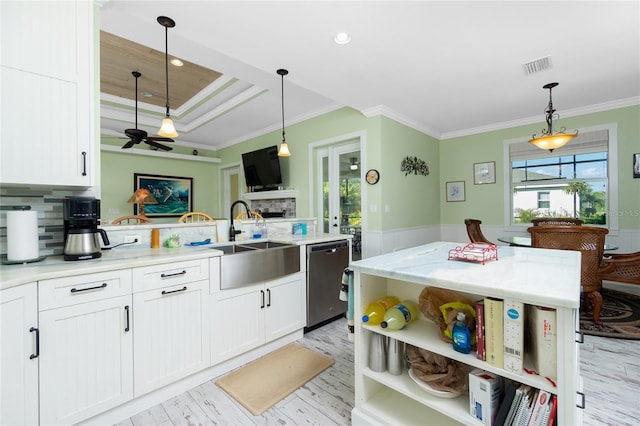 13204 Kakapo Ave, Port Charlotte, FL 33981 - kitchen featuring stainless steel dishwasher, a sink, crown molding, light wood-style floors, and white cabinets