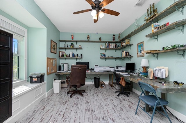 13204 Kakapo Ave, Port Charlotte, FL 33981 - office featuring wood finished floors, built in desk, ceiling fan, and baseboards