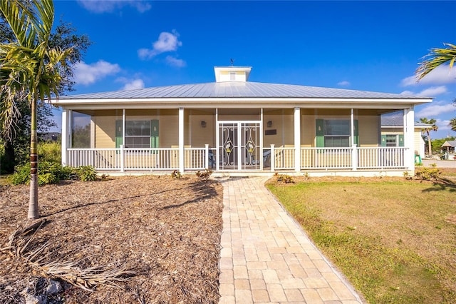 13204 Kakapo Ave, Port Charlotte, FL 33981 - farmhouse with a porch and metal roof