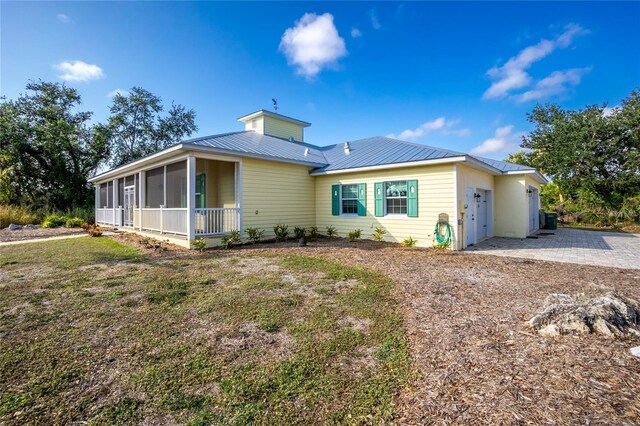 13204 Kakapo Ave, Port Charlotte, FL 33981 - back of property with a sunroom and metal roof